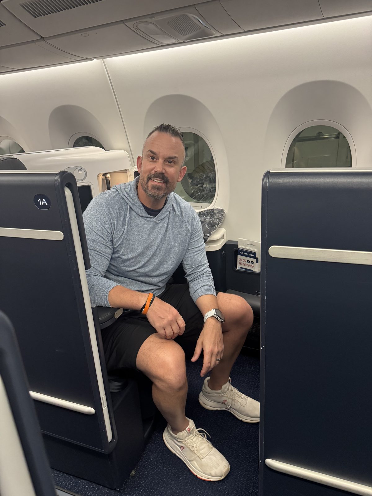 Relaxing in a lie-flat business-class suite on the flight to Paris.